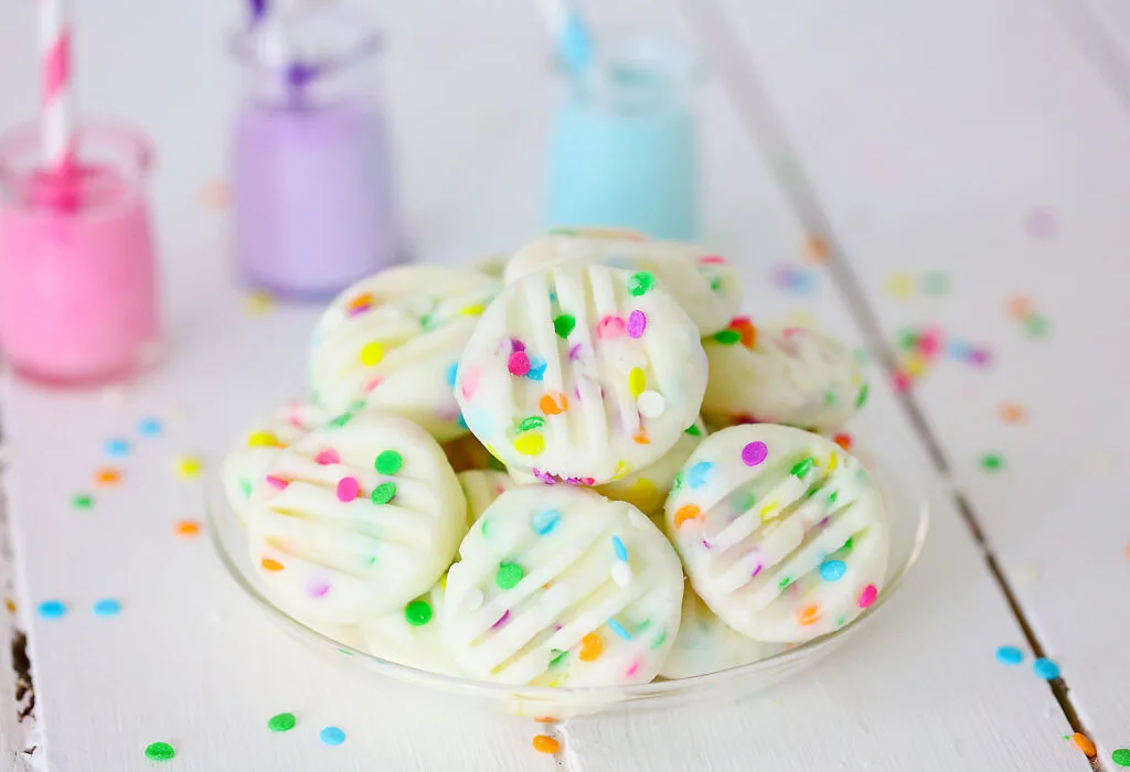 funfetti cream cheese mints on clear plate