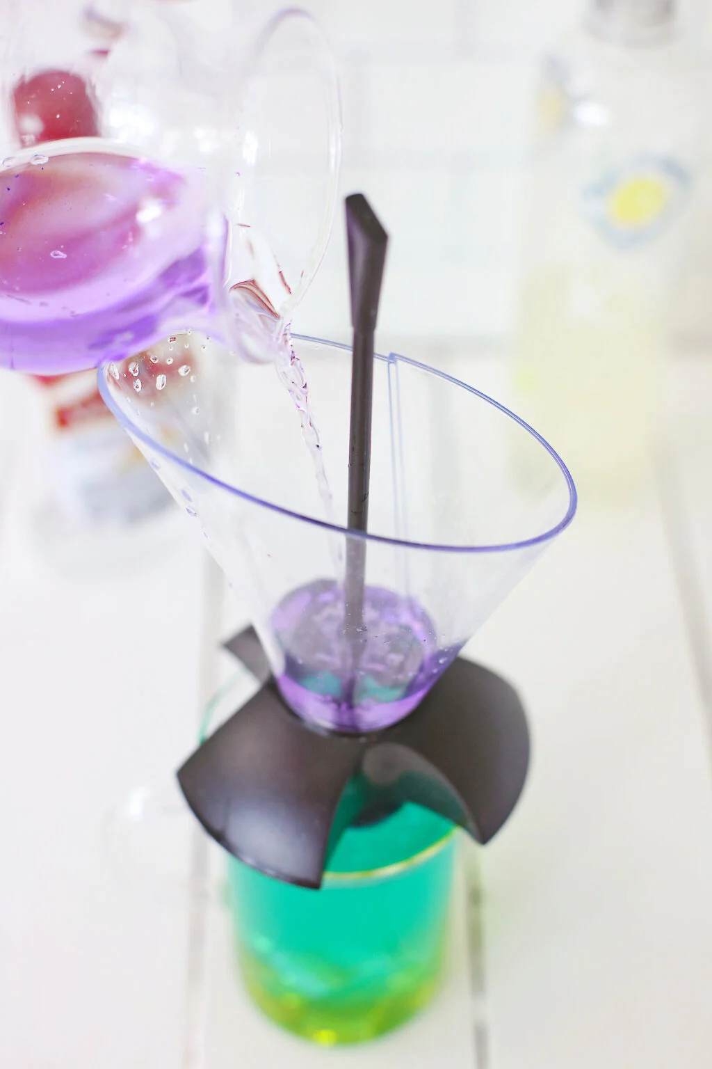 pouring purple layer into drink layering tool