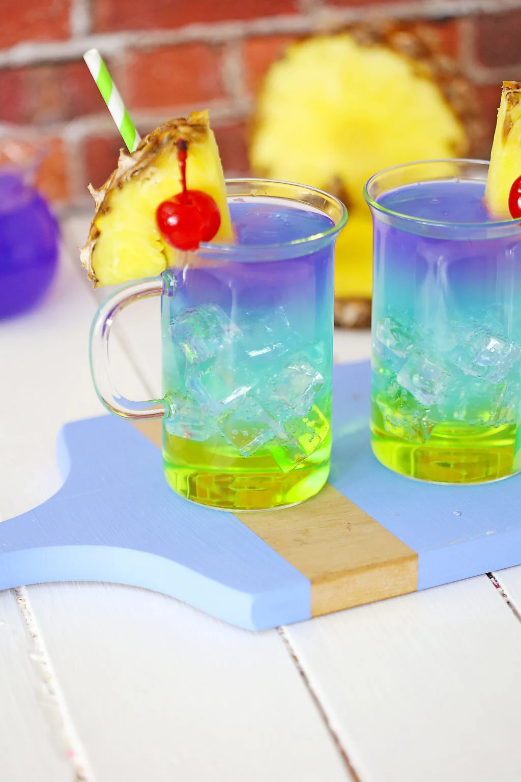 colorful mermaid cocktail in a glass on a cutting board