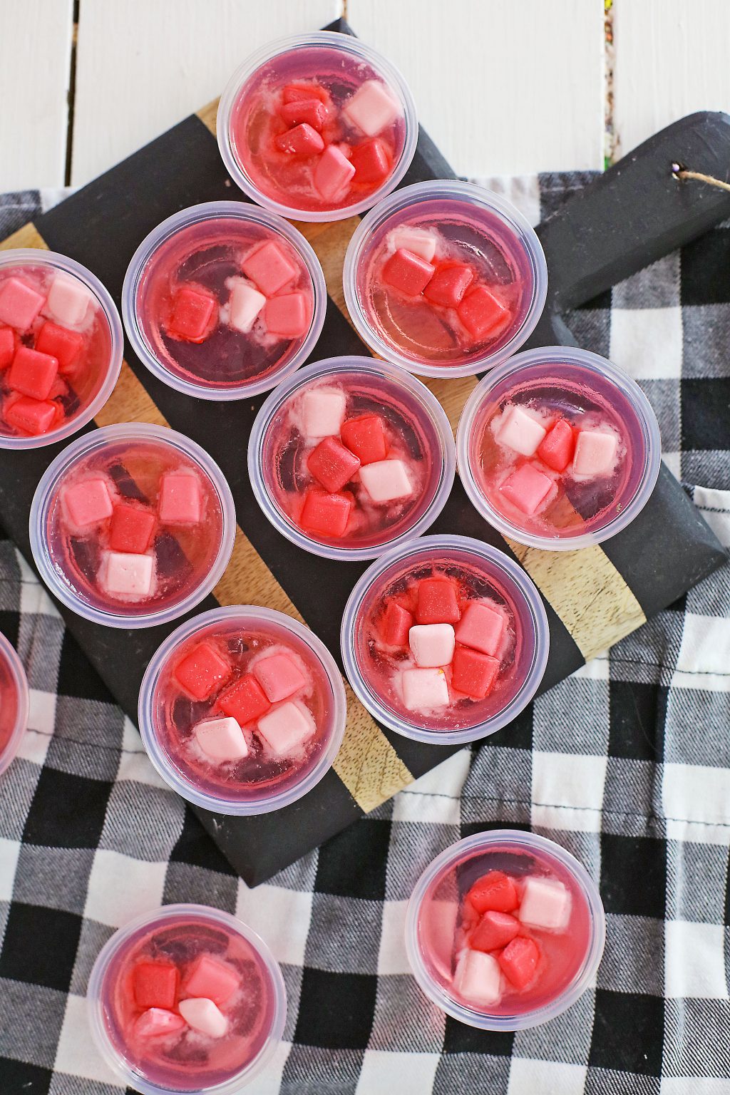 pink starburst jello cups on table