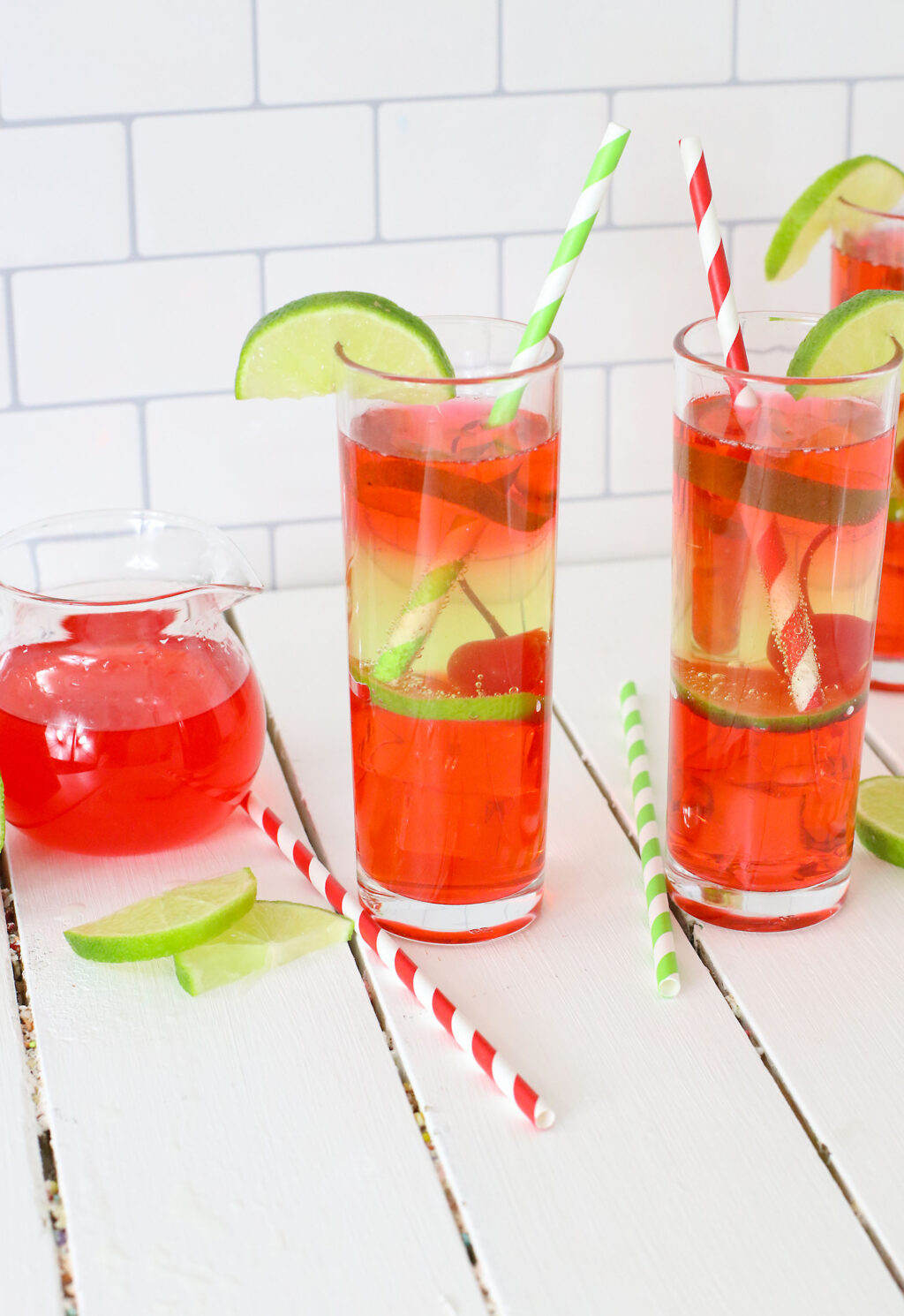 vodka cherry limeade cocktail in a tall glass with a straw
