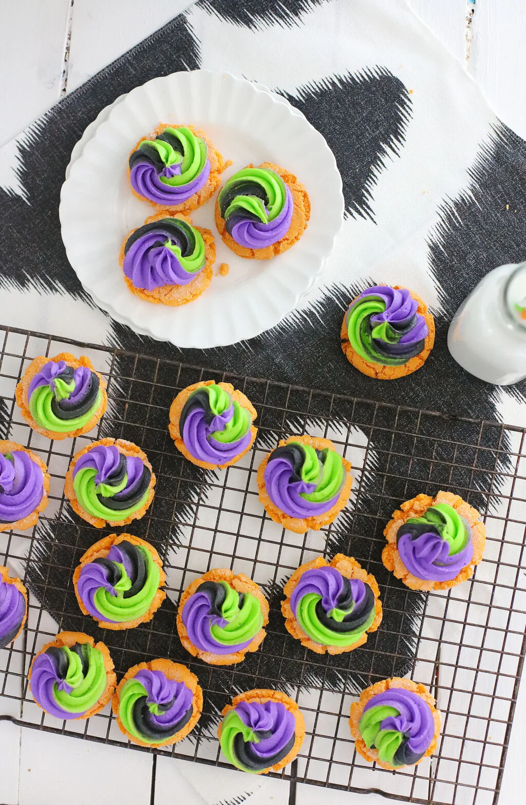 top view of Pumpkin Sugar Cookies With Buttercream Swirl Frosting on a cookie sheet