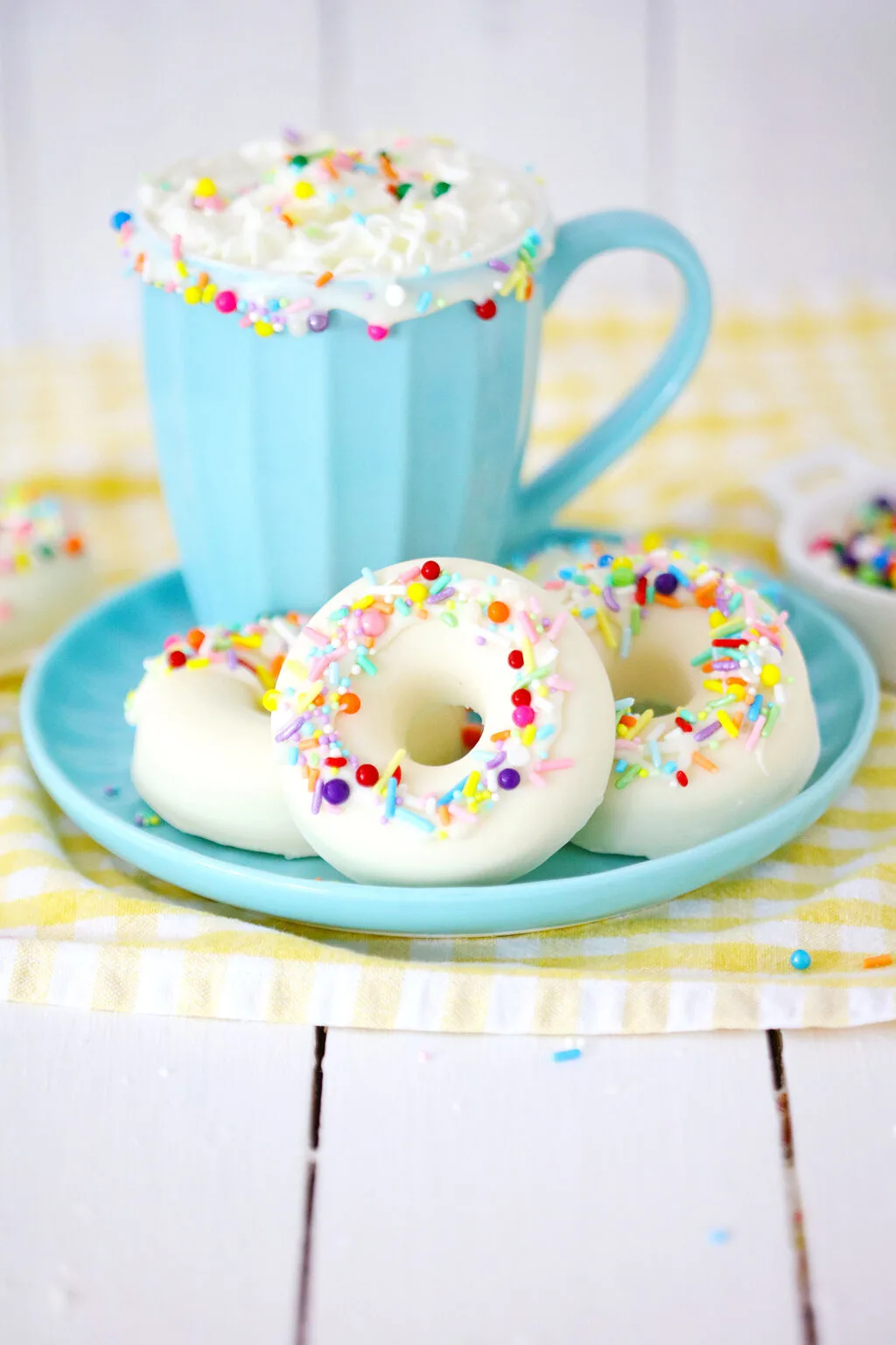 white chocolate donut hot cocoa bombs on blue plate