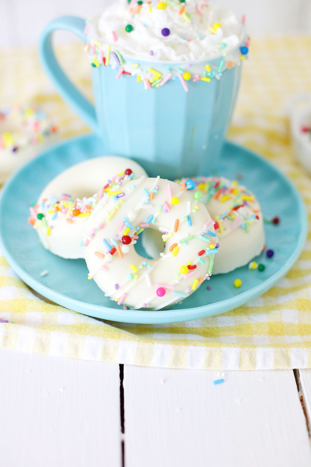 white chocolate donut hot cocoa bombs on blue plate