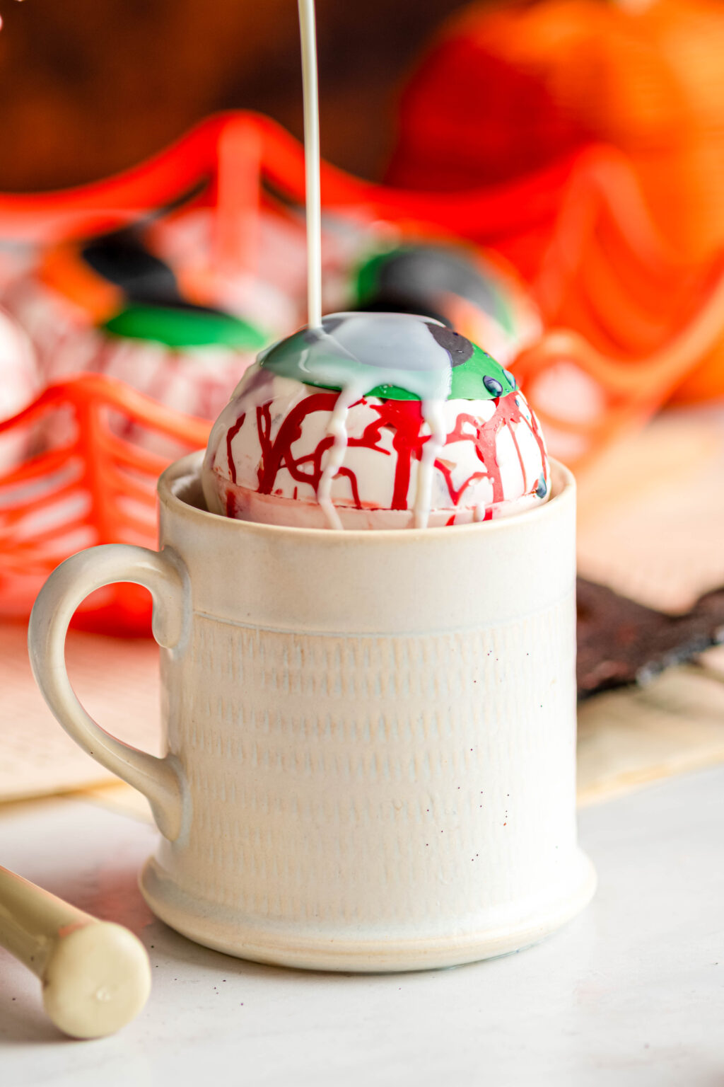 eyeball hot cocoa bombs in an white mug