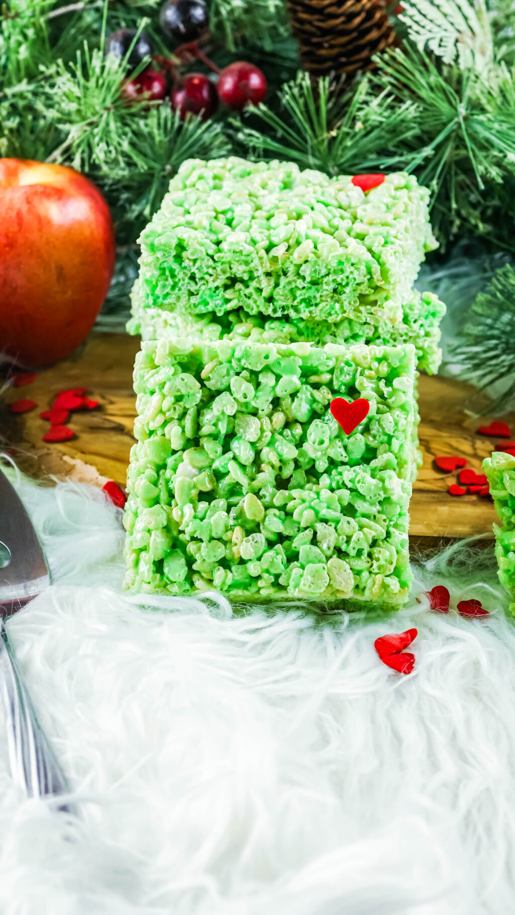 green grinch rice krispies treat stacked on wood plate
