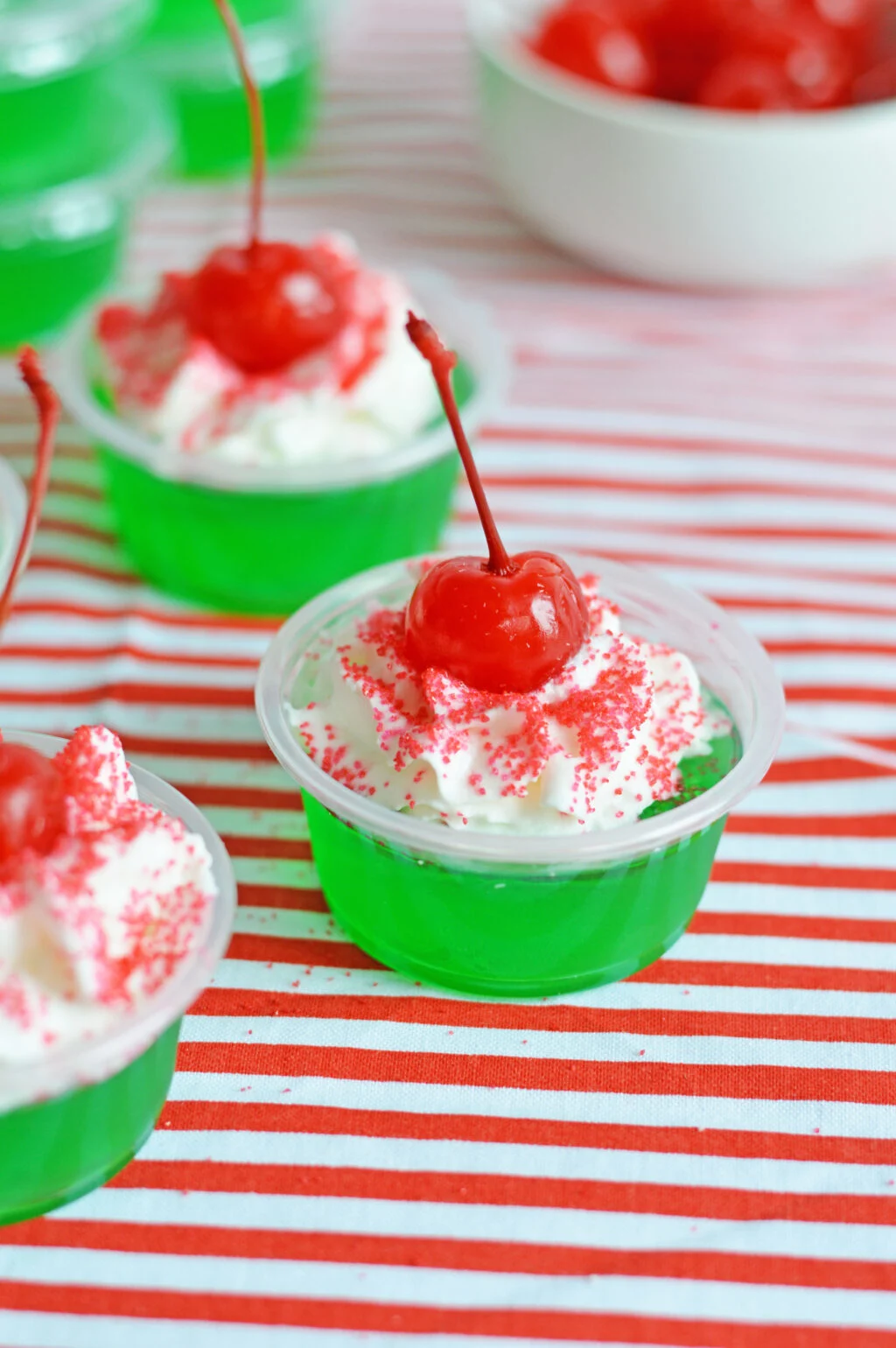 christmas jello shots on a red and white table cloth