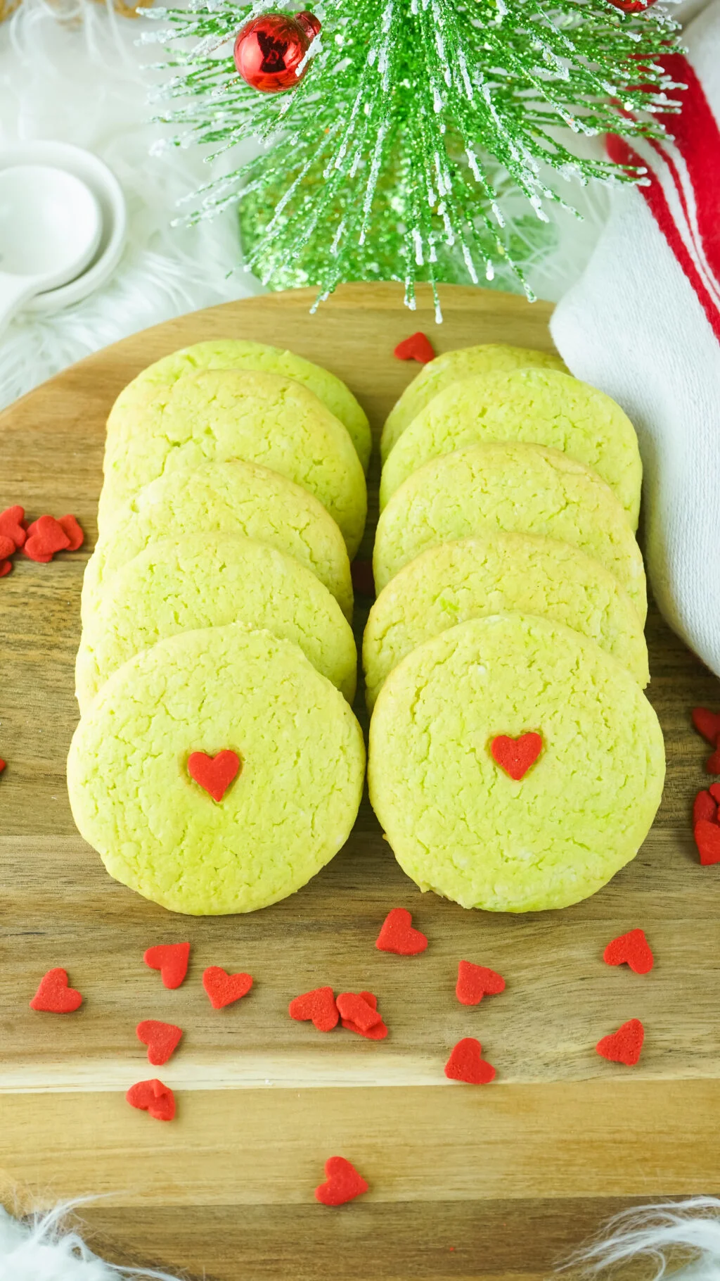 grinch cake mix cookies lined up on a wood board