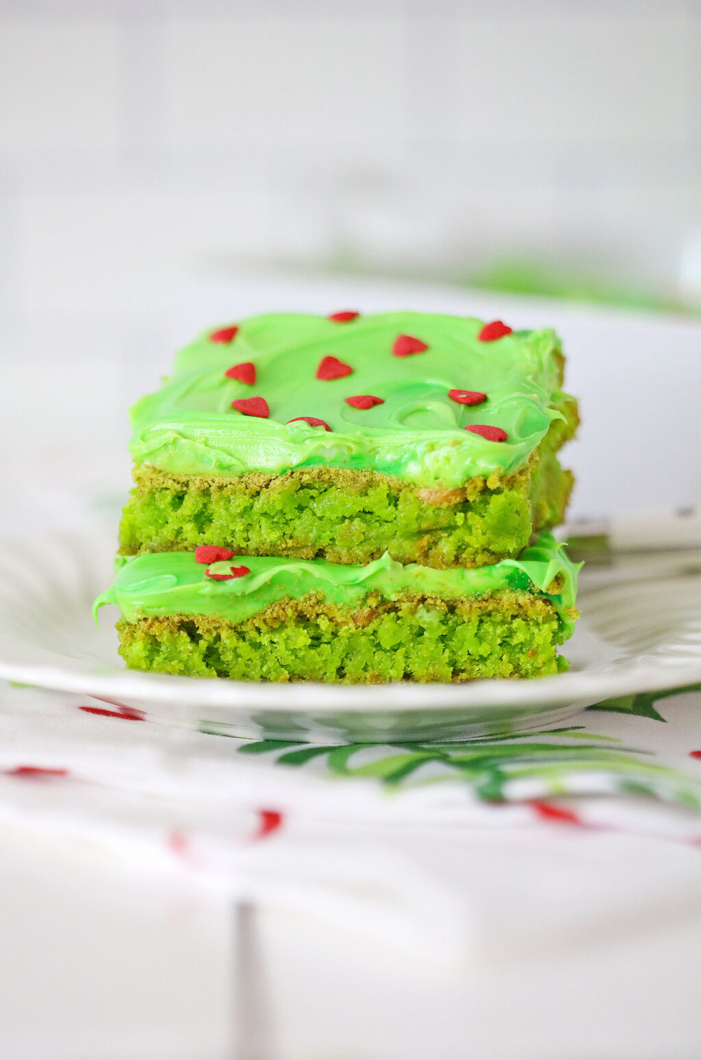 grinch brownies stacked on white plate