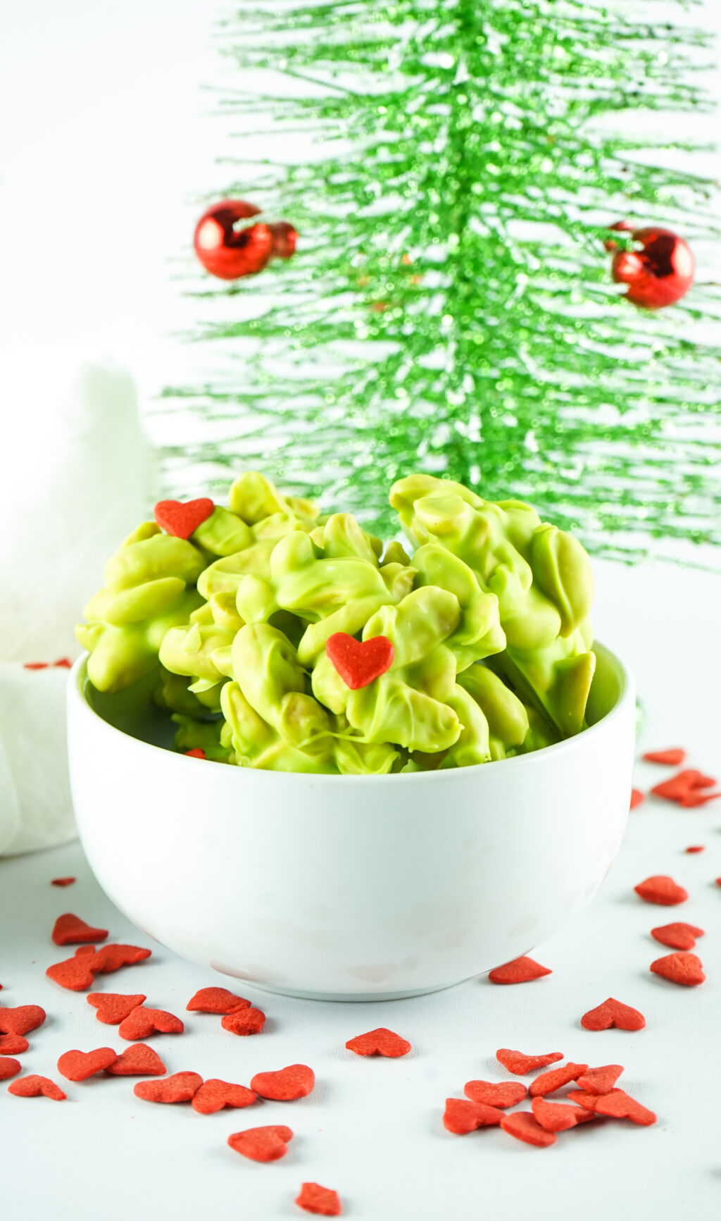 grinch peanut clusters in white bowl