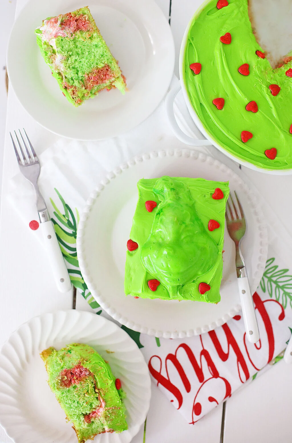 slices of grinch cake on round white plates