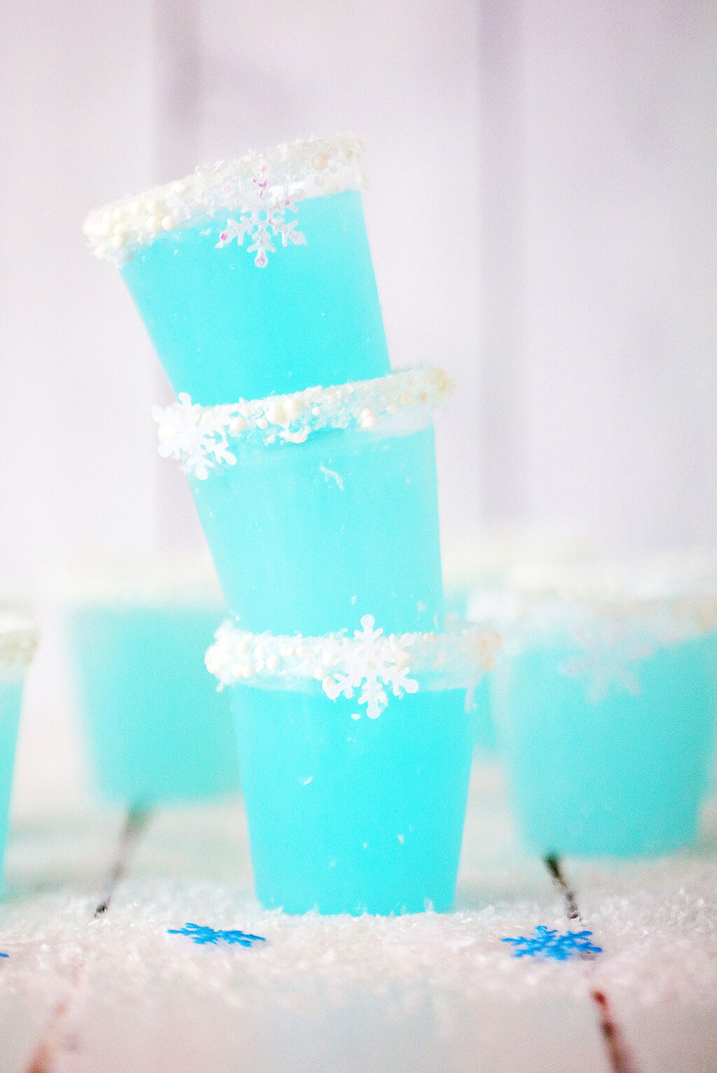 three jack frost jello shots stacked on top of a white wood table