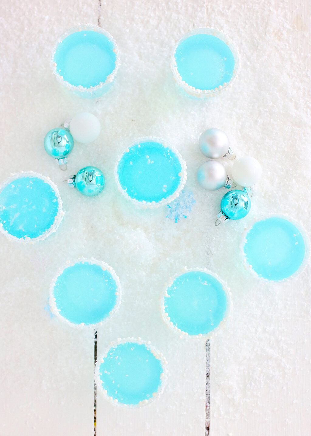 top view of jack frost jello shots on a white wood table