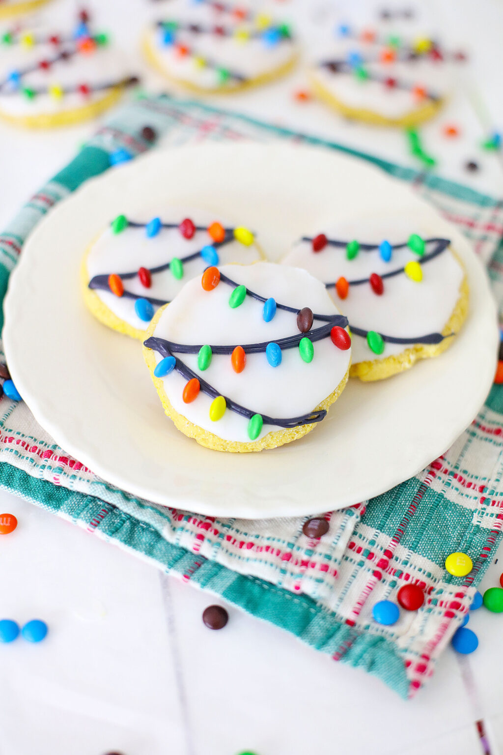christmas lights cookies on a white plate