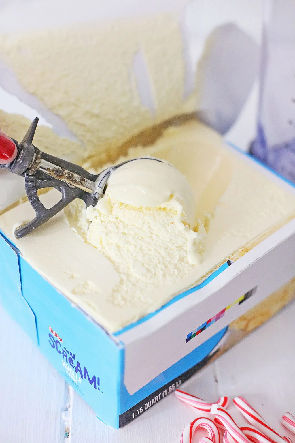 woman scooping vanilla ice cream