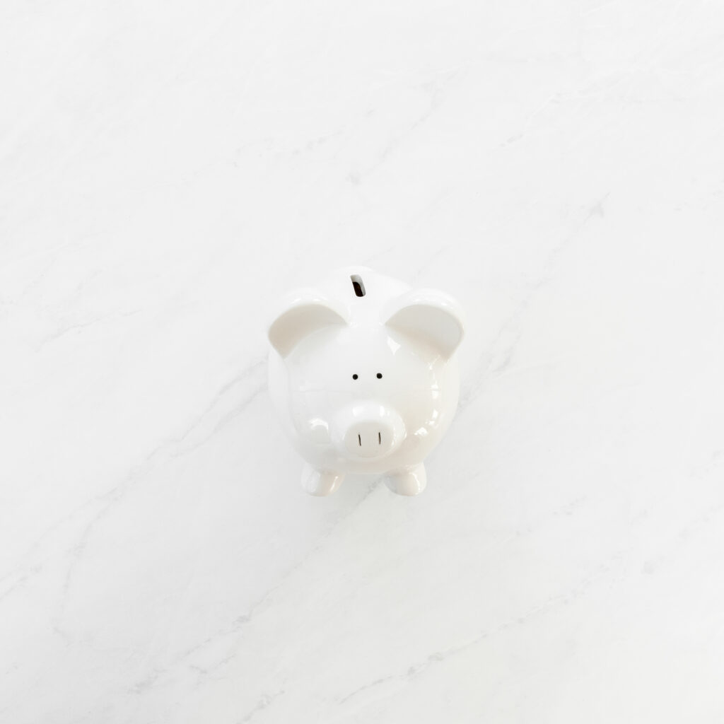 white piggy bank on a table for a no spend january challenge
