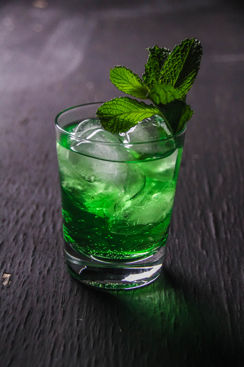 luck of the irish cocktail in a clear glass with ice and fresh mint