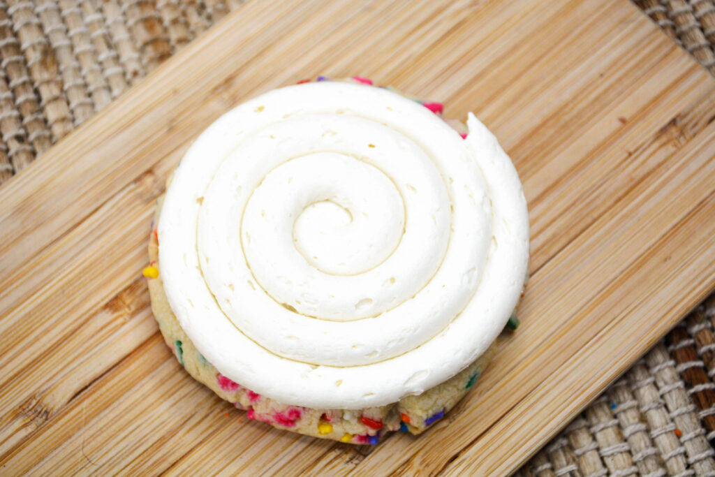swirled frosting on top of funfetti cookies