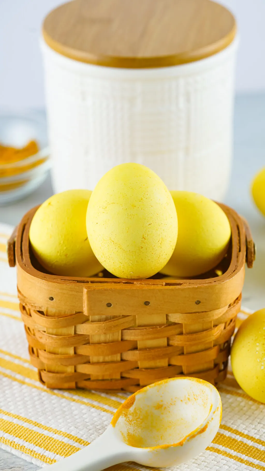 naturally colored yellow eggs in a brown basket