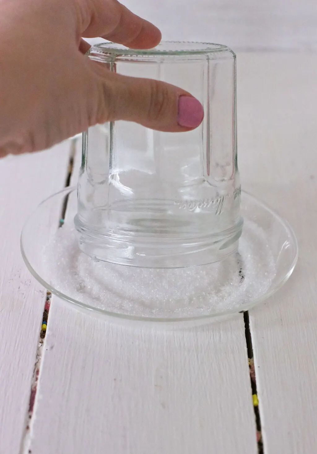 clear glass rim being dipped into sugar
