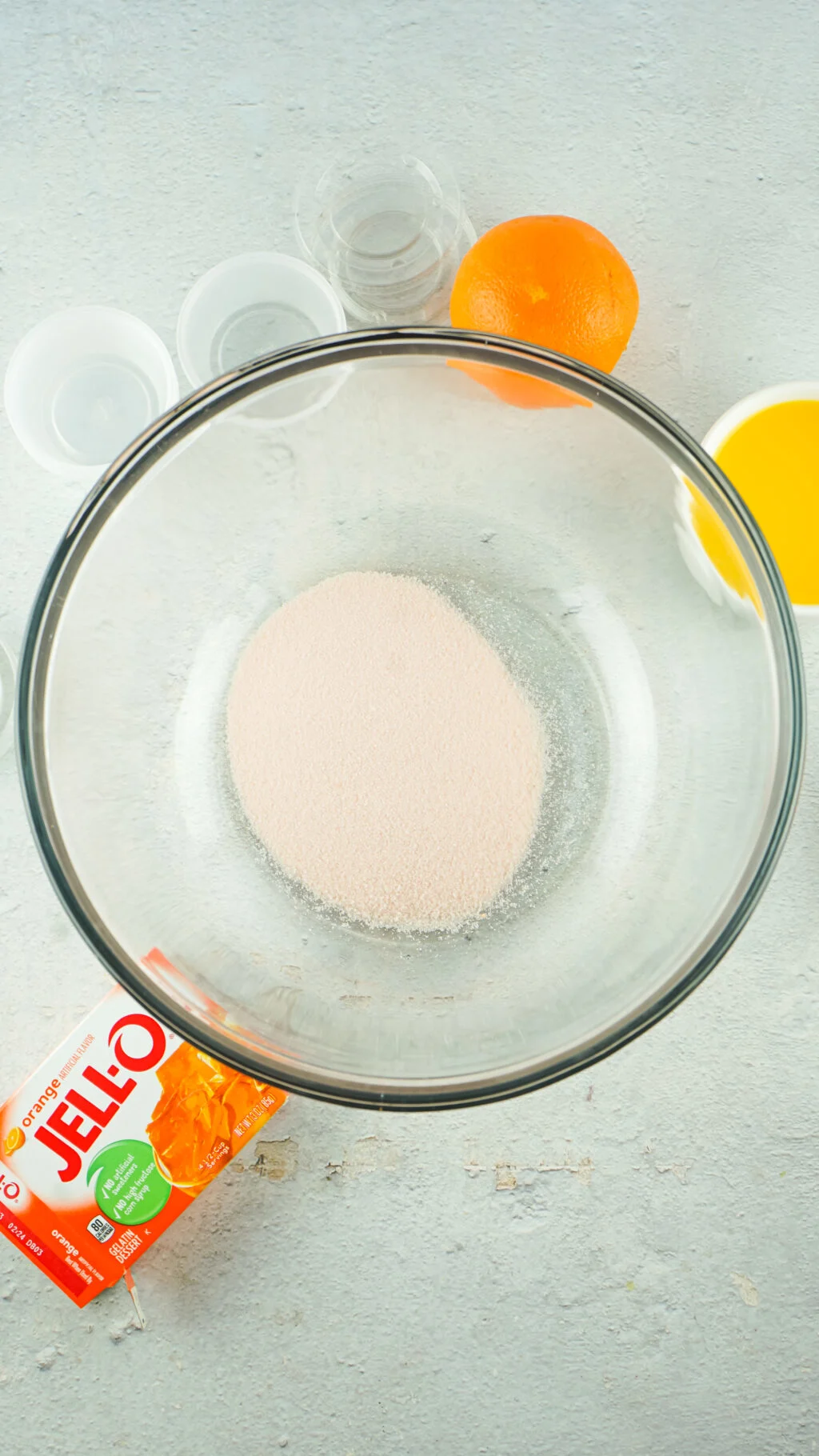 orange jello mix in a clear bowl