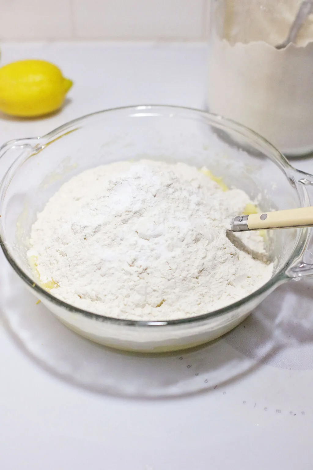 flour being added to wet cookie ingredients