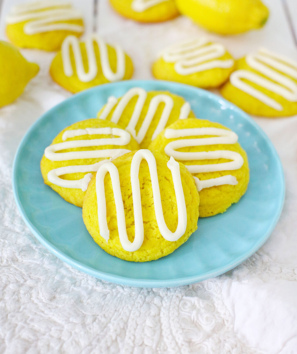bright yellow lemon cream cheese cookies on a blue plate
