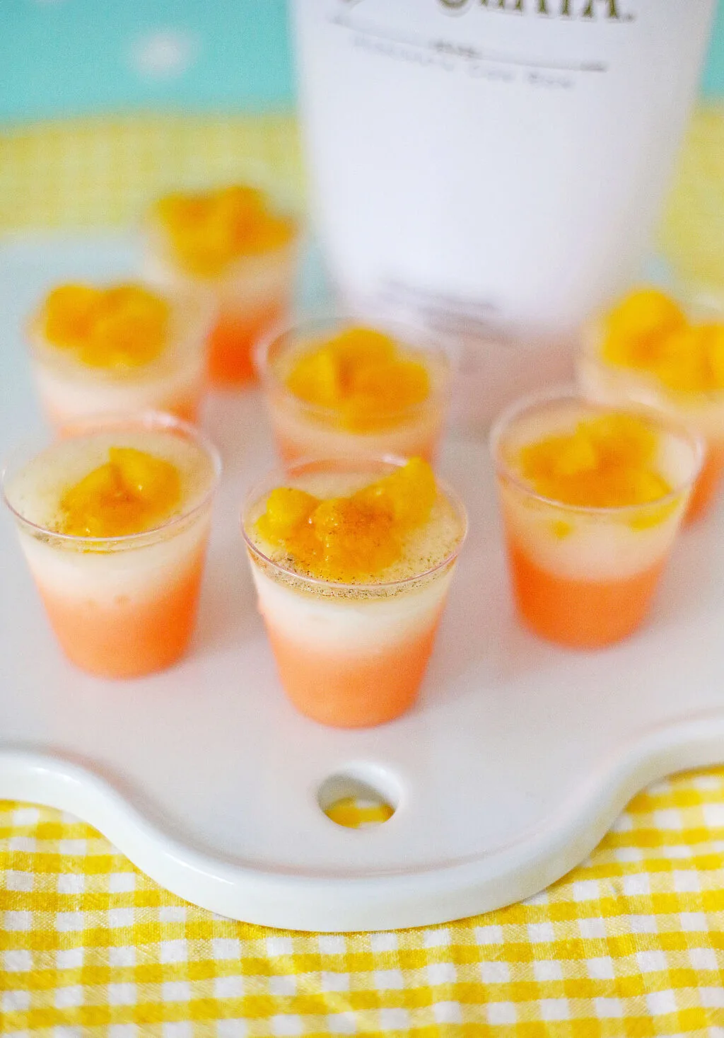 peach jello shots on table with yellow napkin