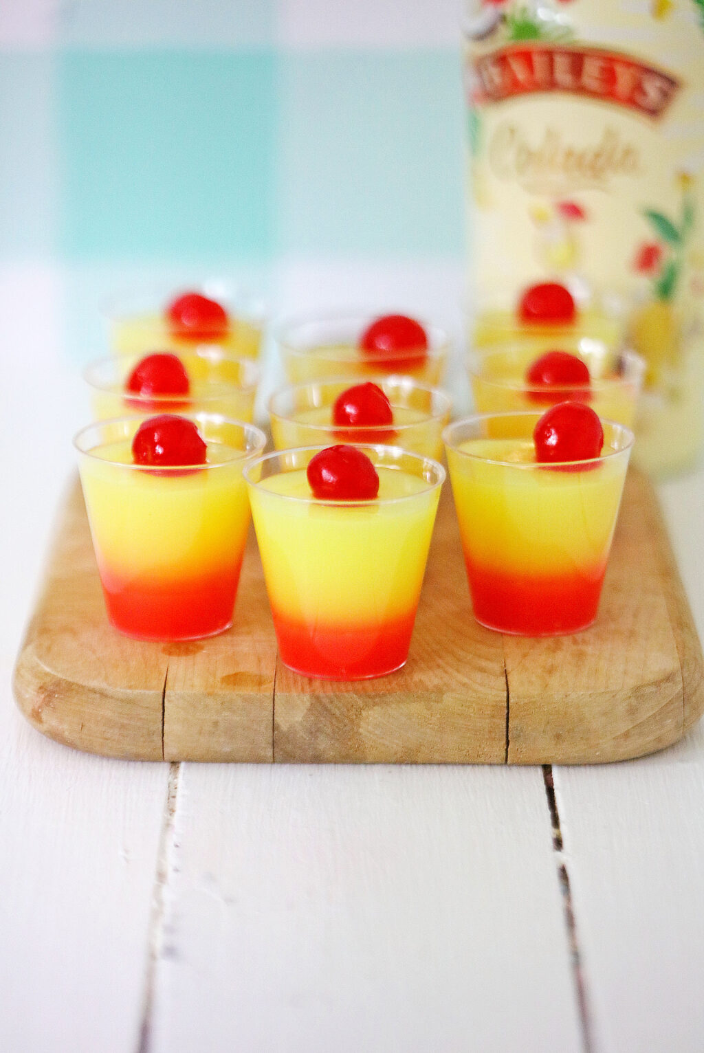 sunrise jello shots made with rum on wood table