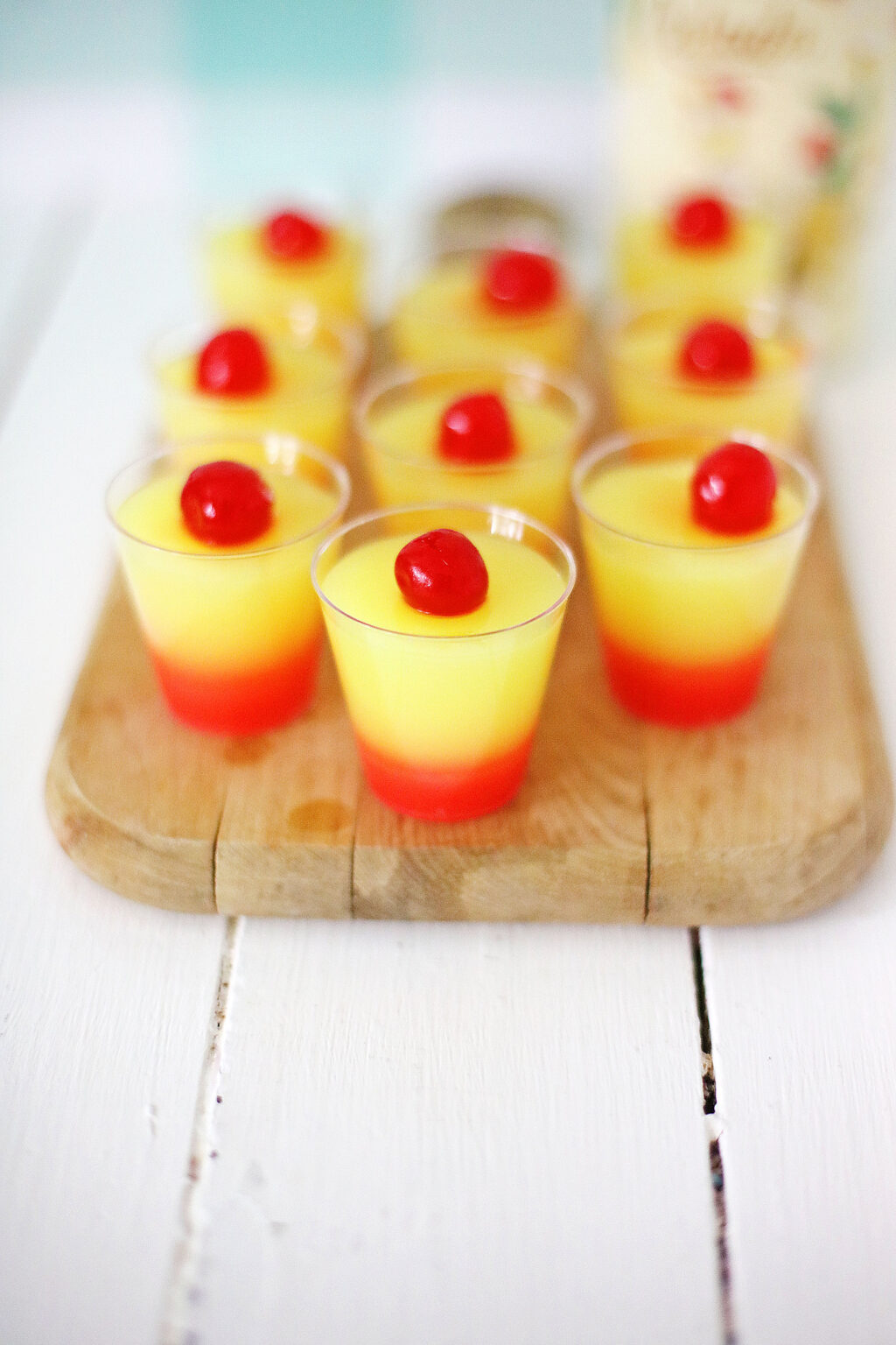 colored jello shots on white wood table