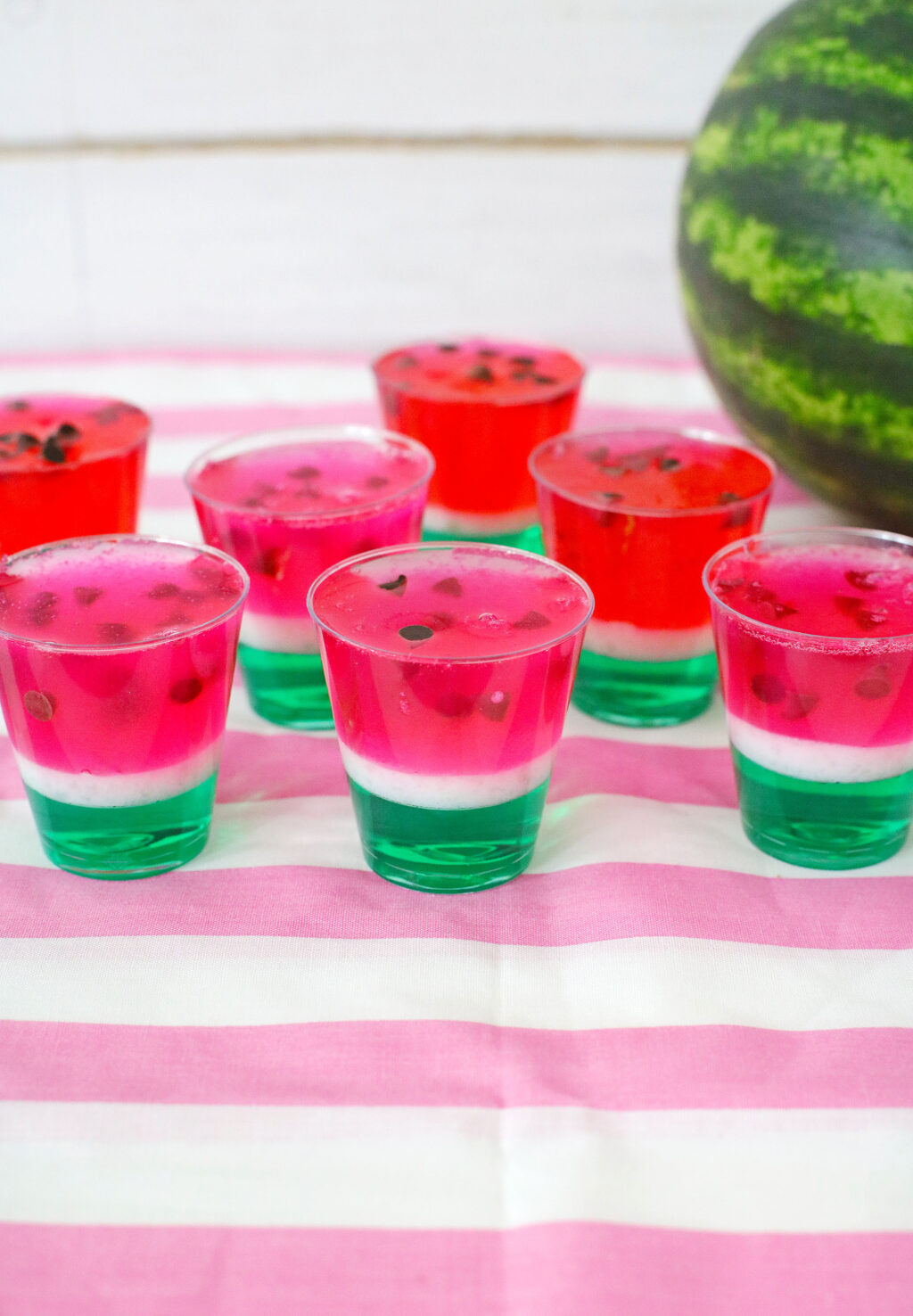 watermelon jello shots on pink cloth on table