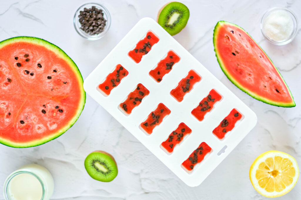 making homemade watermelon popsicles in popsicle mold
