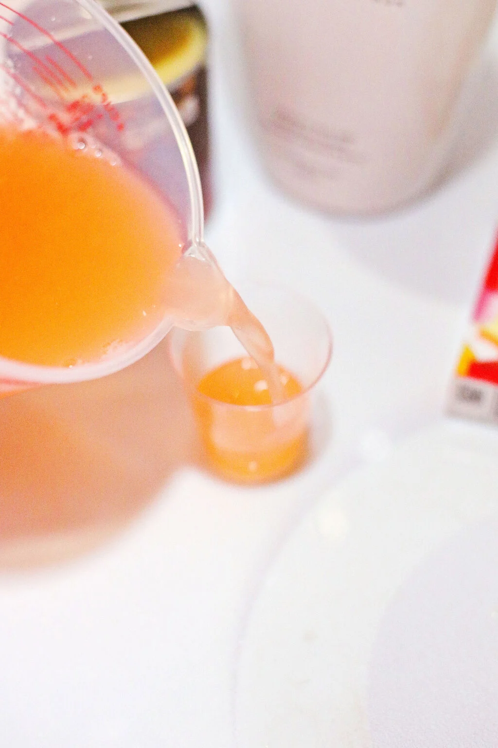 peach jello mixture poured into shot glass