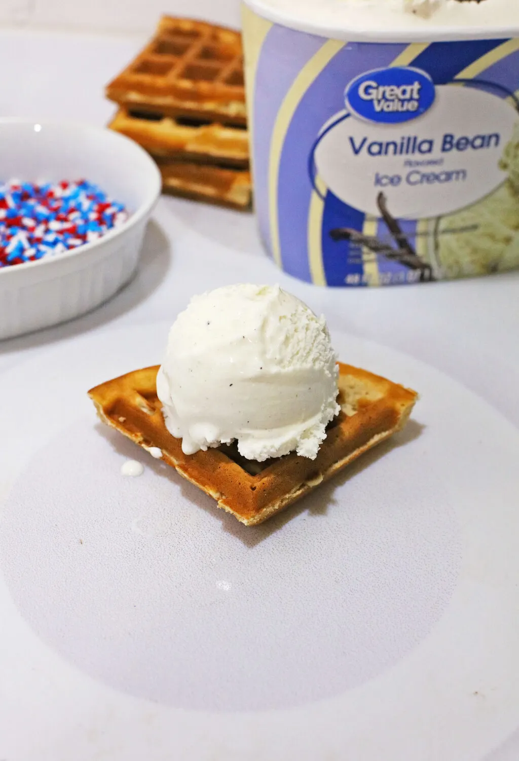 scoop of vanilla ice cream on a piece of waffle