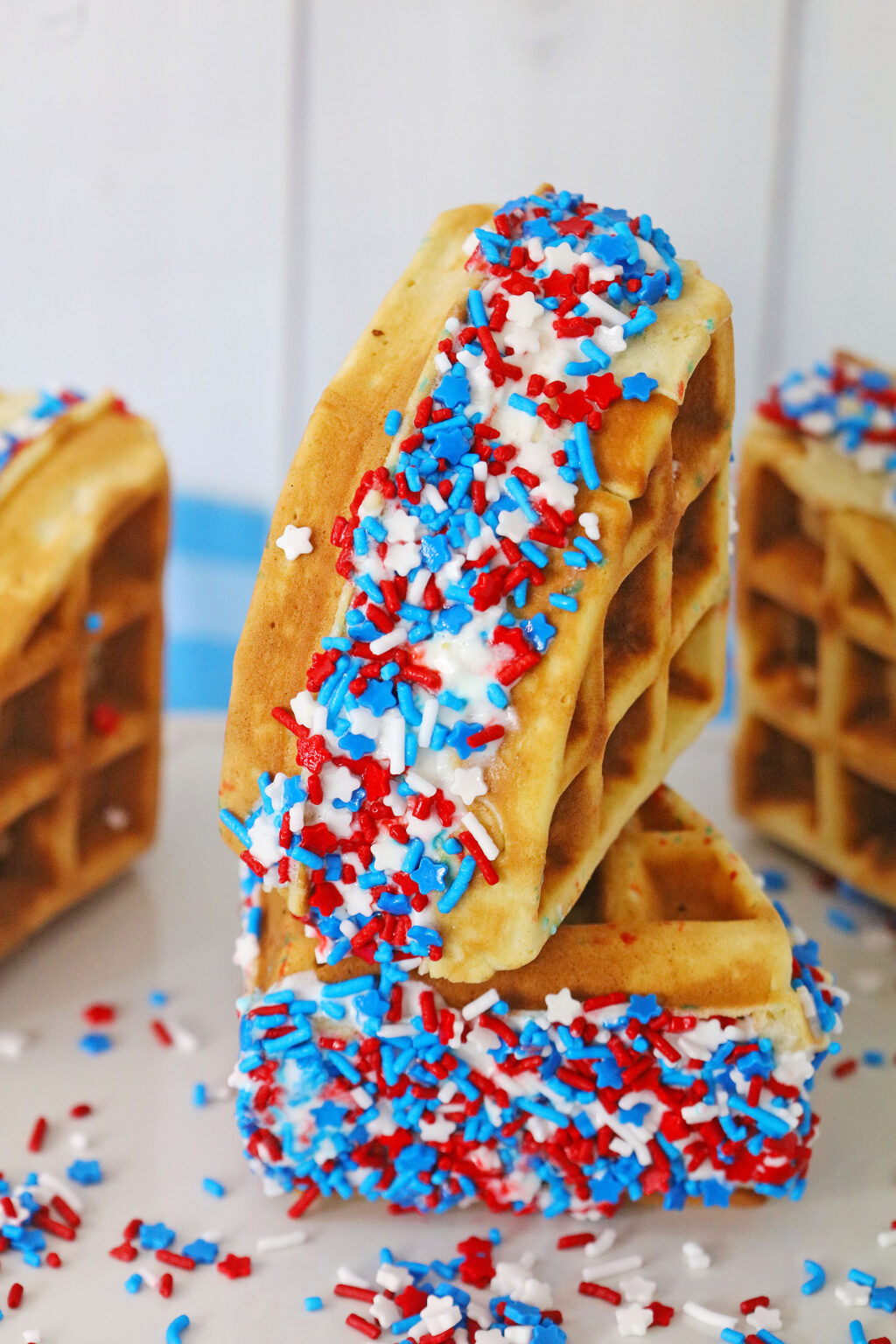stacked waffle ice cream sandwiches on a white table