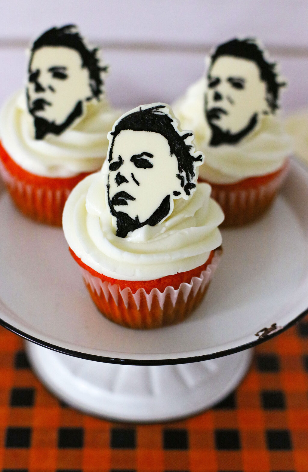 michael myers cupcakes on plaid tablecloth on top of cupcake stand