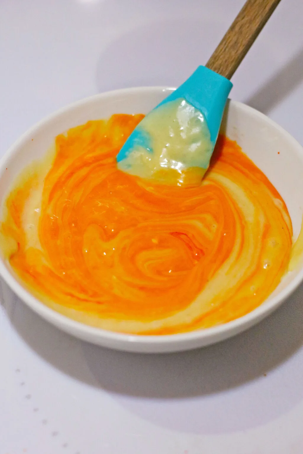 orange food coloring added to cupcake batter