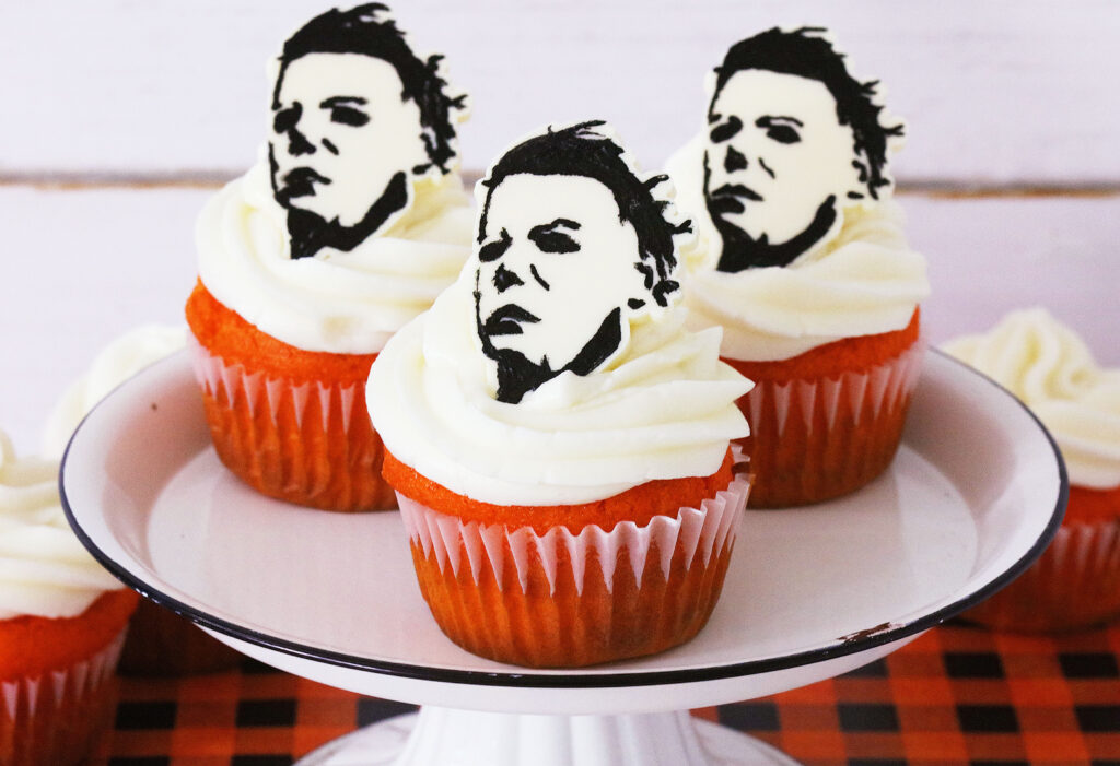 michael myers halloween cupcakes on a white round cake stand