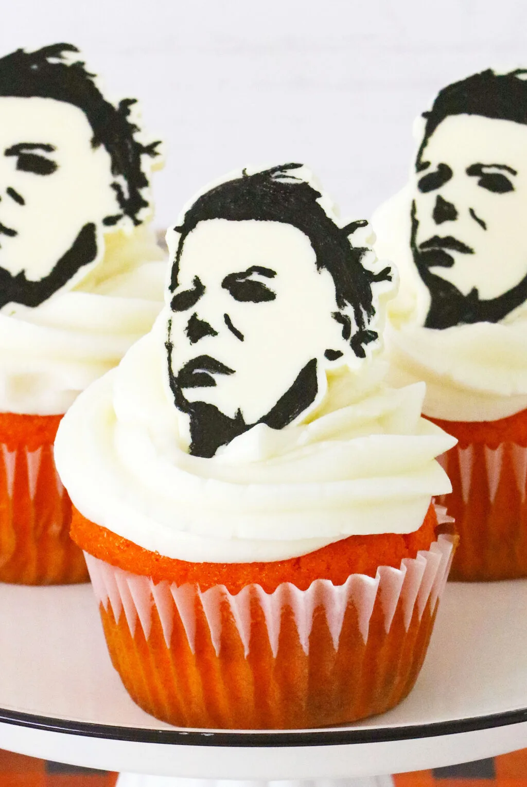 michael myers cupcakes on white cake stand