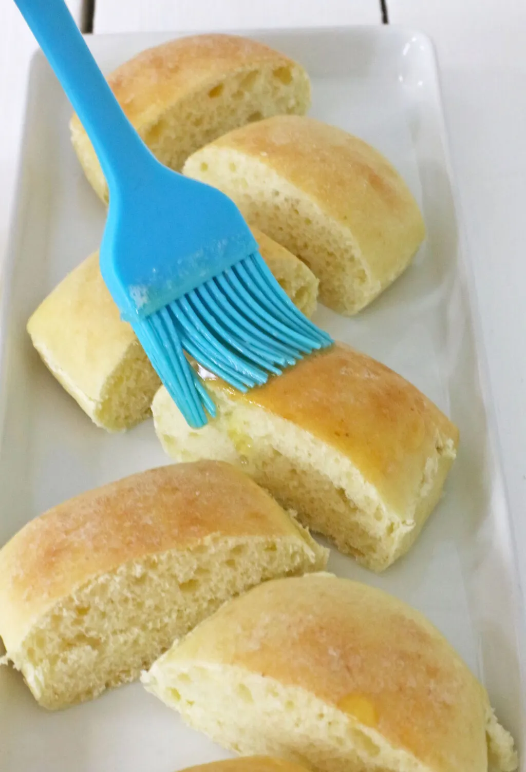 putting honey butter on top of rolls