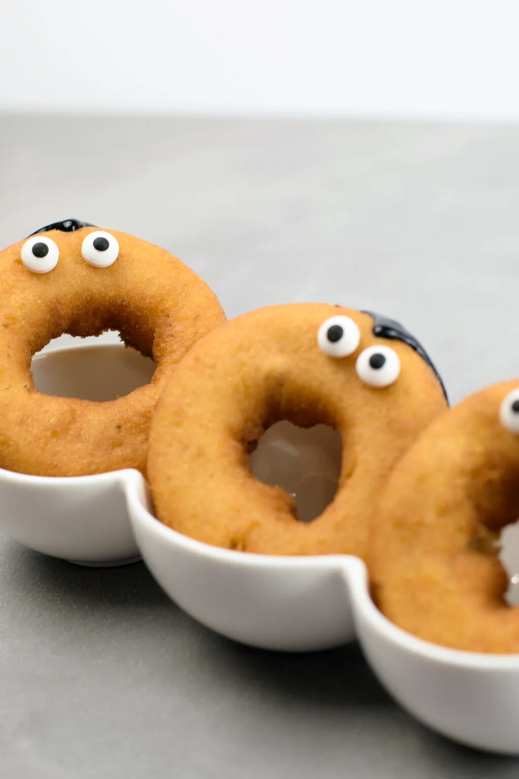 candy eyeballs on donuts to look like vampire eyes