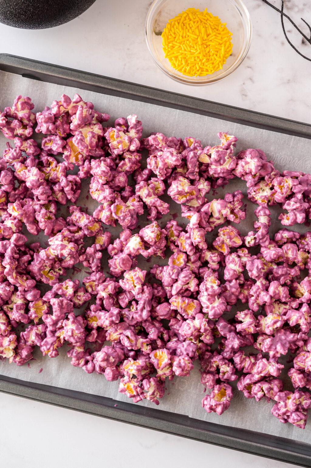 colored popcorn on cookie sheet