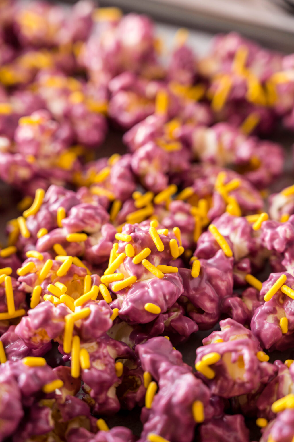 purple colored popcorn with yellow sprinkles