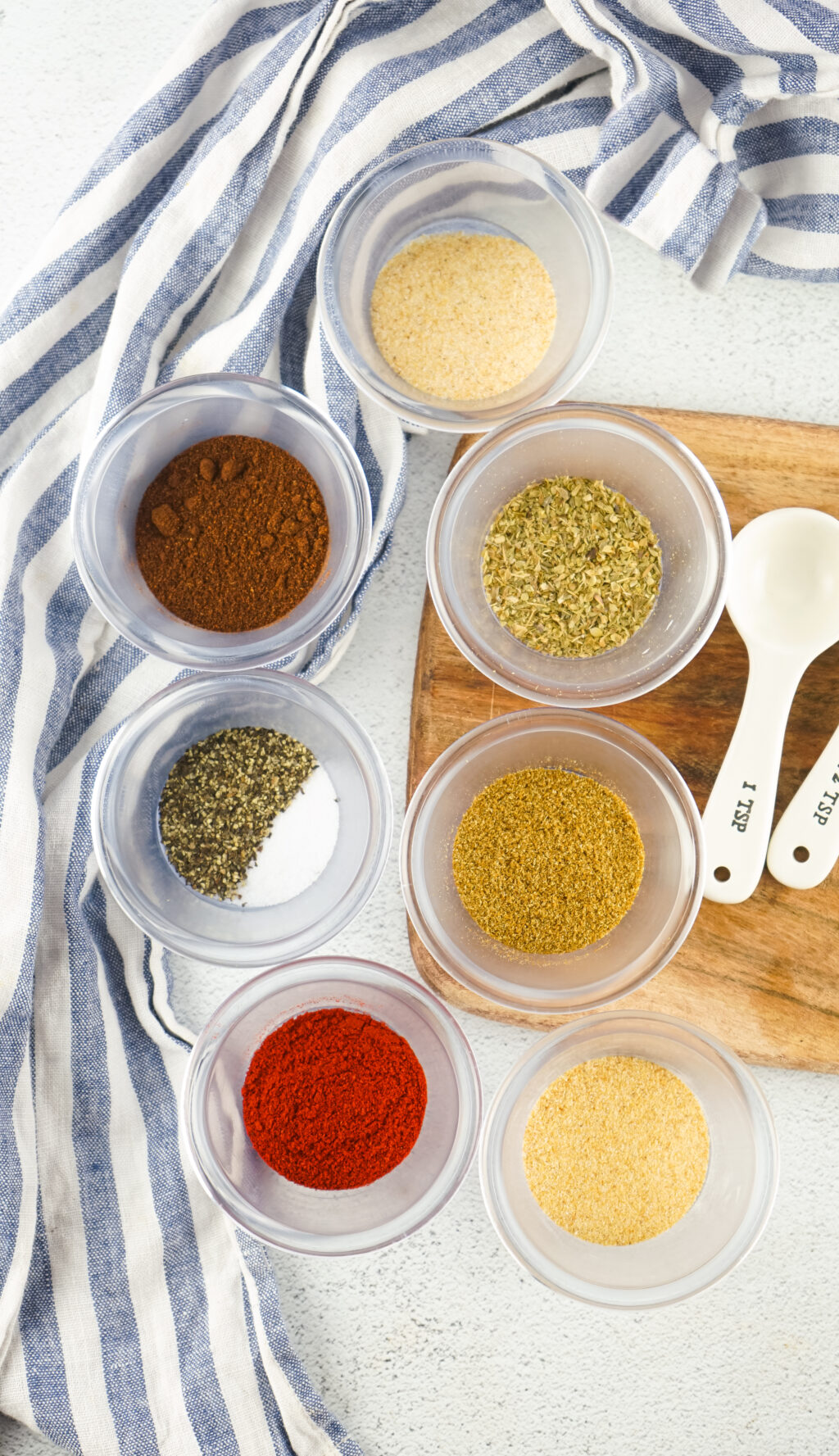 taco seasoning ingredients in small glass bowls on table