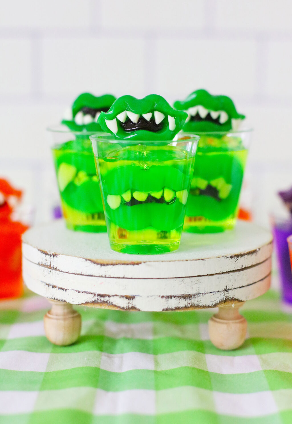 green monster teeth jello shots on cake stand