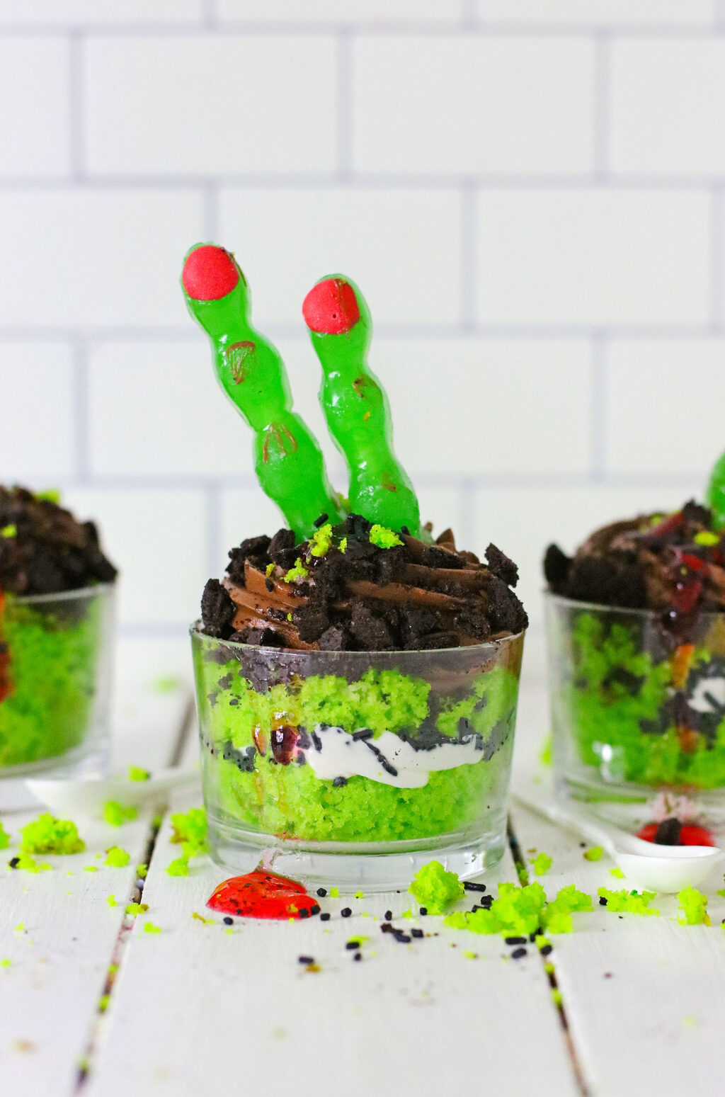zombie finger cakes in glass bowls on white wood table