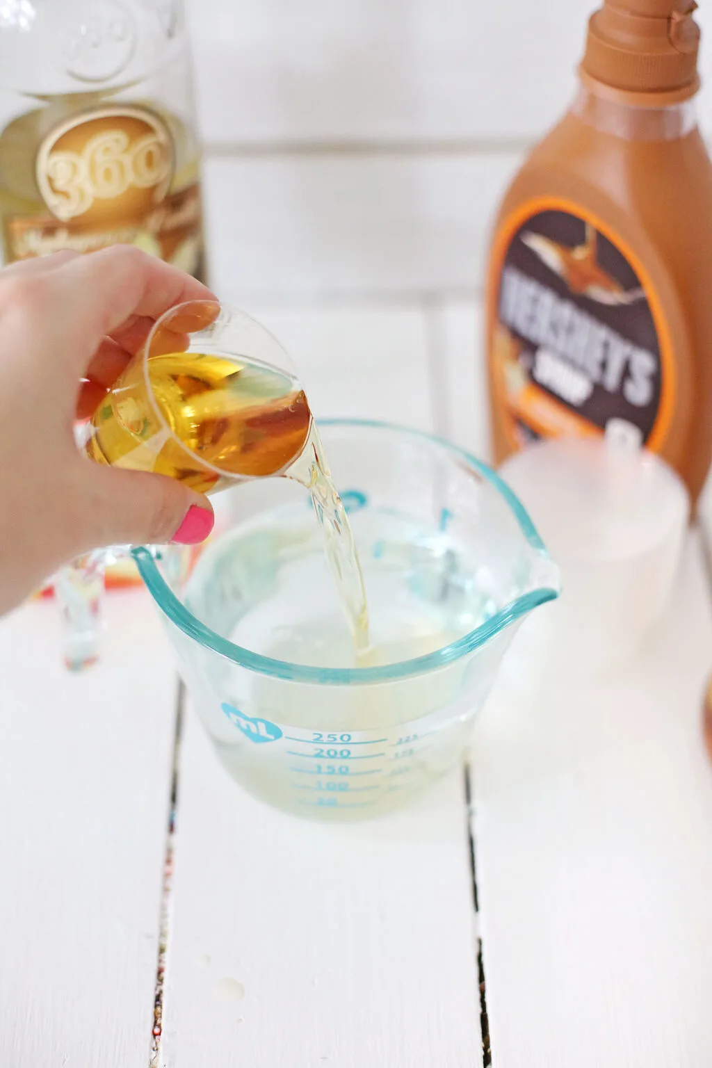 alcohol being poured into jello mixture