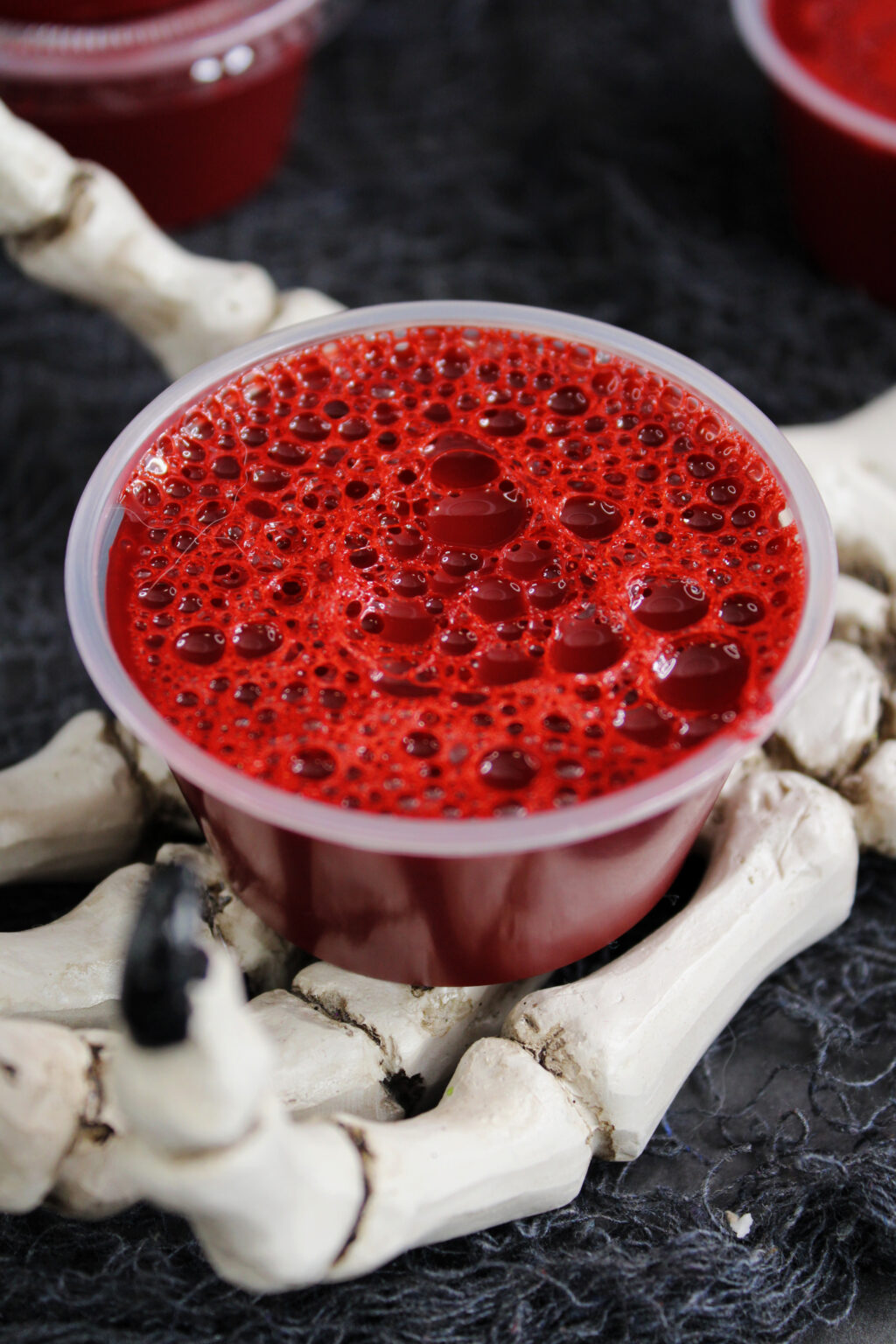 bloody jello shots on fake skeleton hand