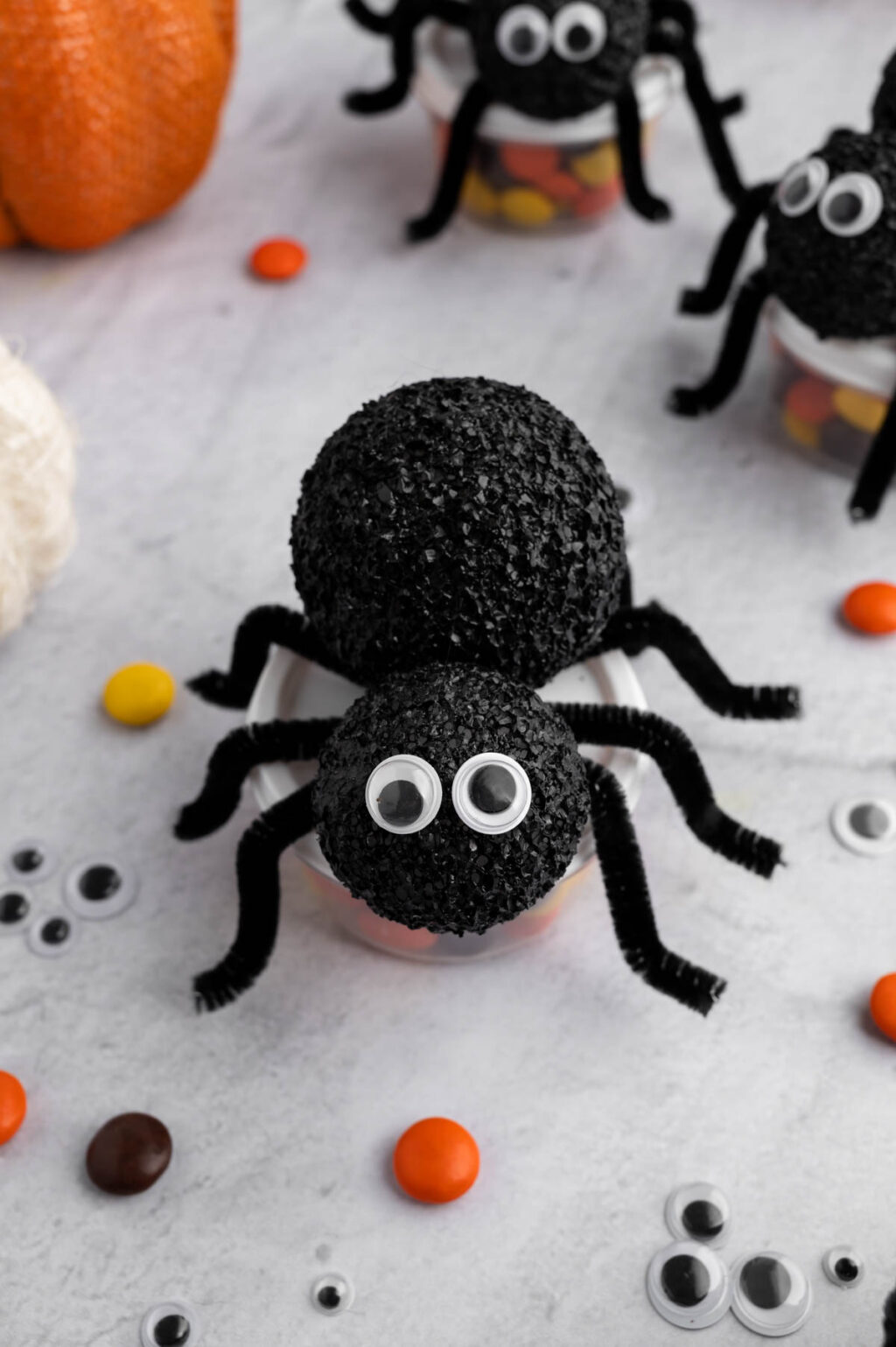spider treat container filled with candy on table