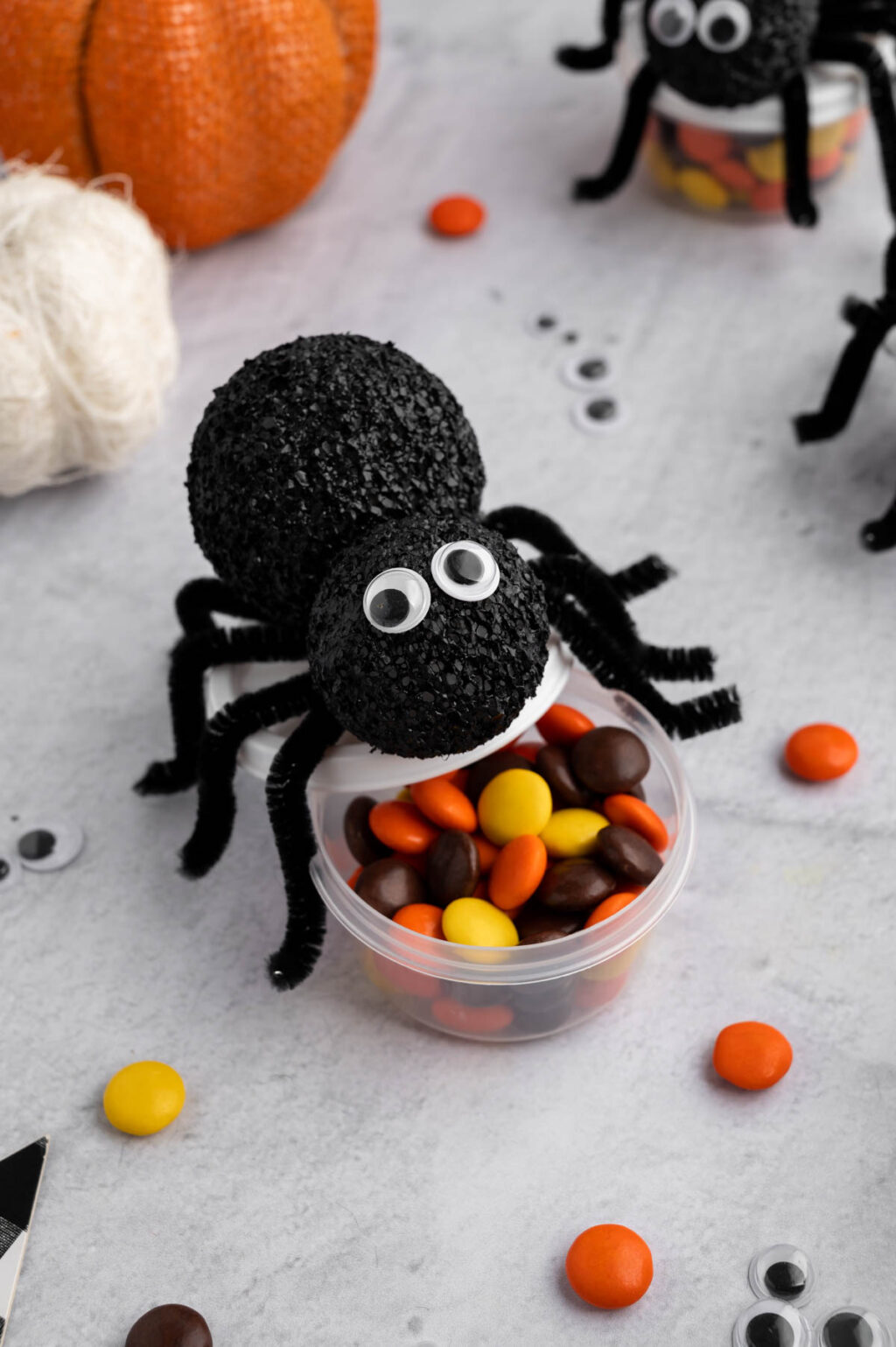spider treat containers filled with candy on table